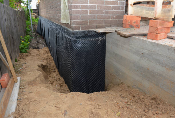 SJ Waterproofing Pros technician performing targeted Wet Basement Repair assessment in Bethlehem, KY